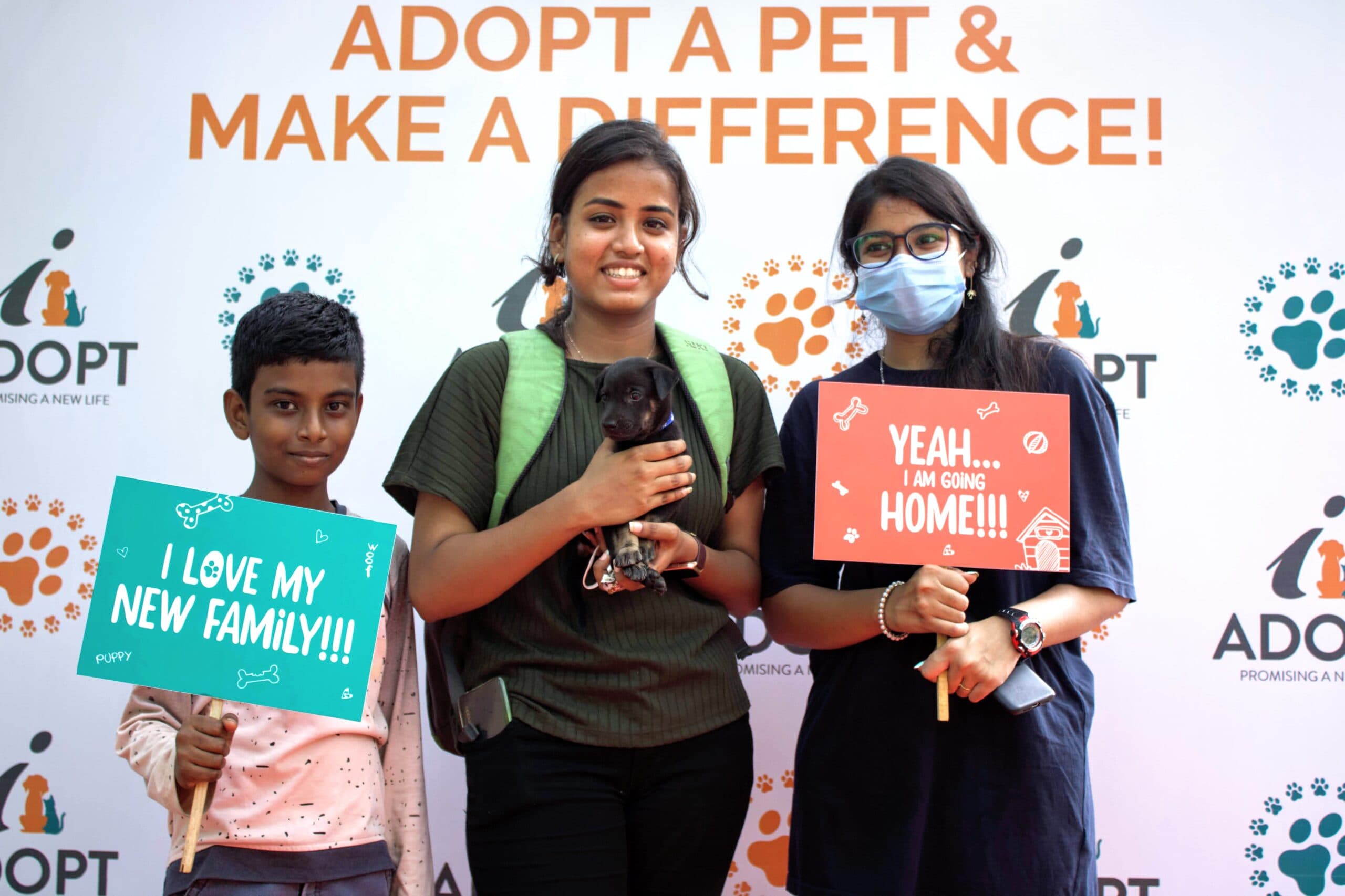 A young adopter holding a rescued puppy at an iAdopt adoption drive