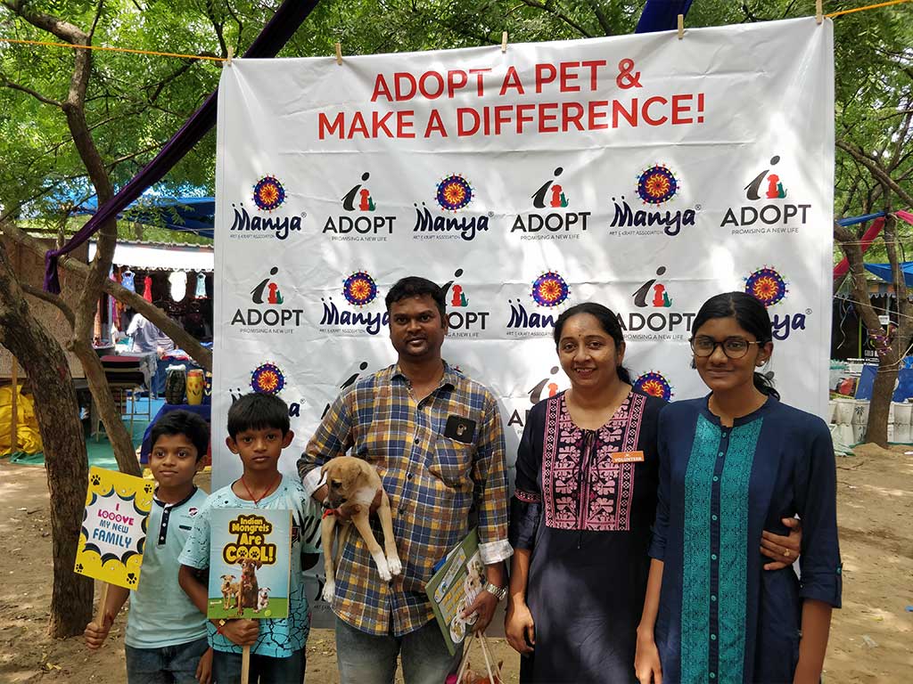 A family with their newly adopted puppy at an iAdopt adoption drive